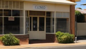 Empty storefront with Closed sign on door, representing why small businesses fail australia in their third year